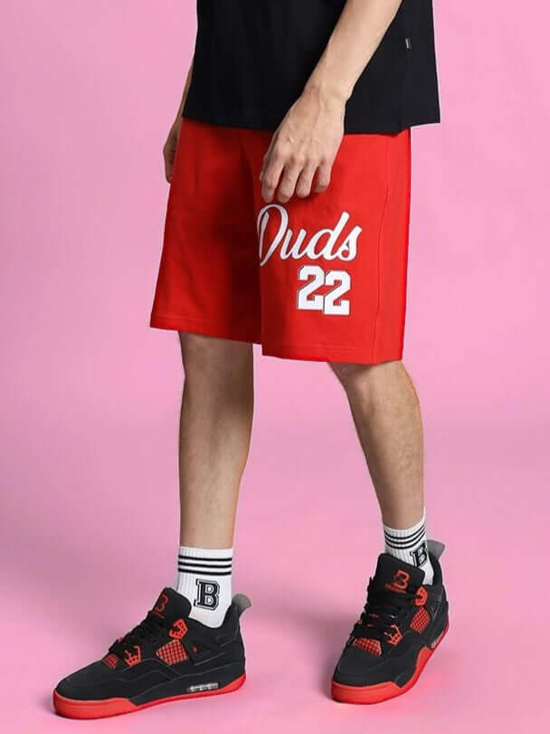 Man wearing Columbia 22 Regular Fit Shorts Red, showcasing vibrant design and casual athletic style