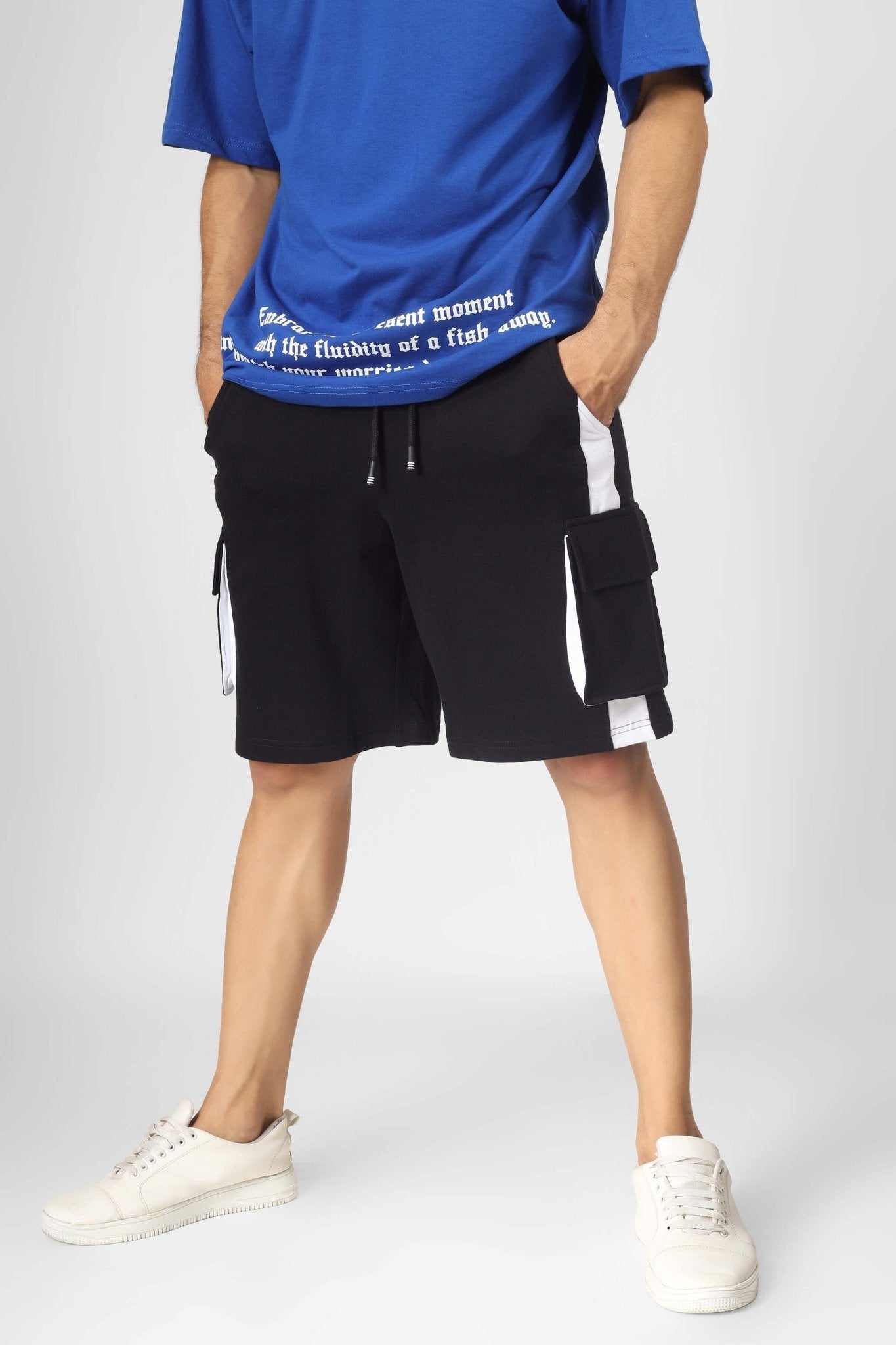 Model wearing CONTRA REGULAR FIT CARGO SHORTS BLACK WHITE with contrasting black-and-white design for streetwear style.