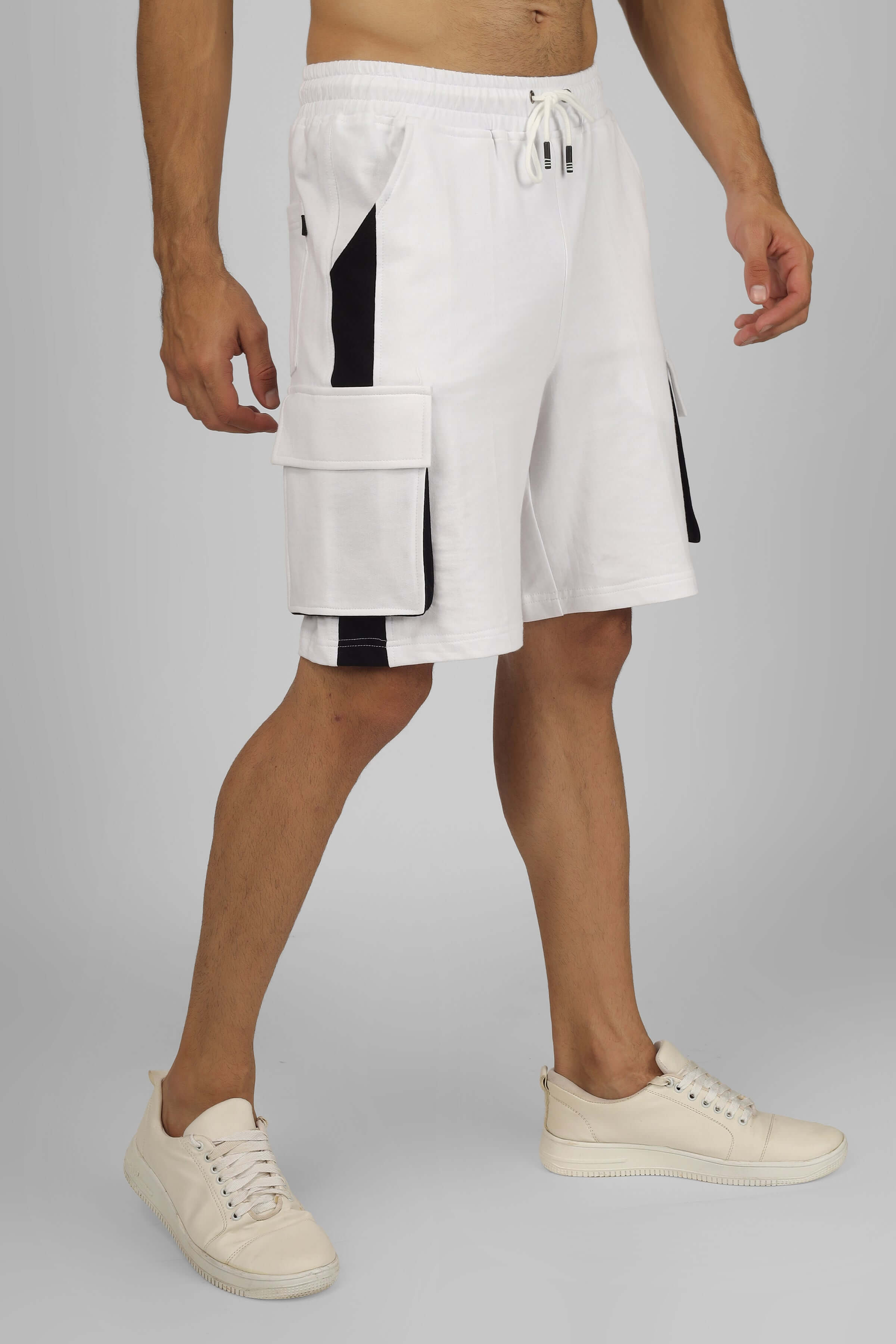 Alt Tag: Contra Regular Fit Cargo Shorts in white and black, featuring adjustable fit and spacious pockets, styled with white sneakers.