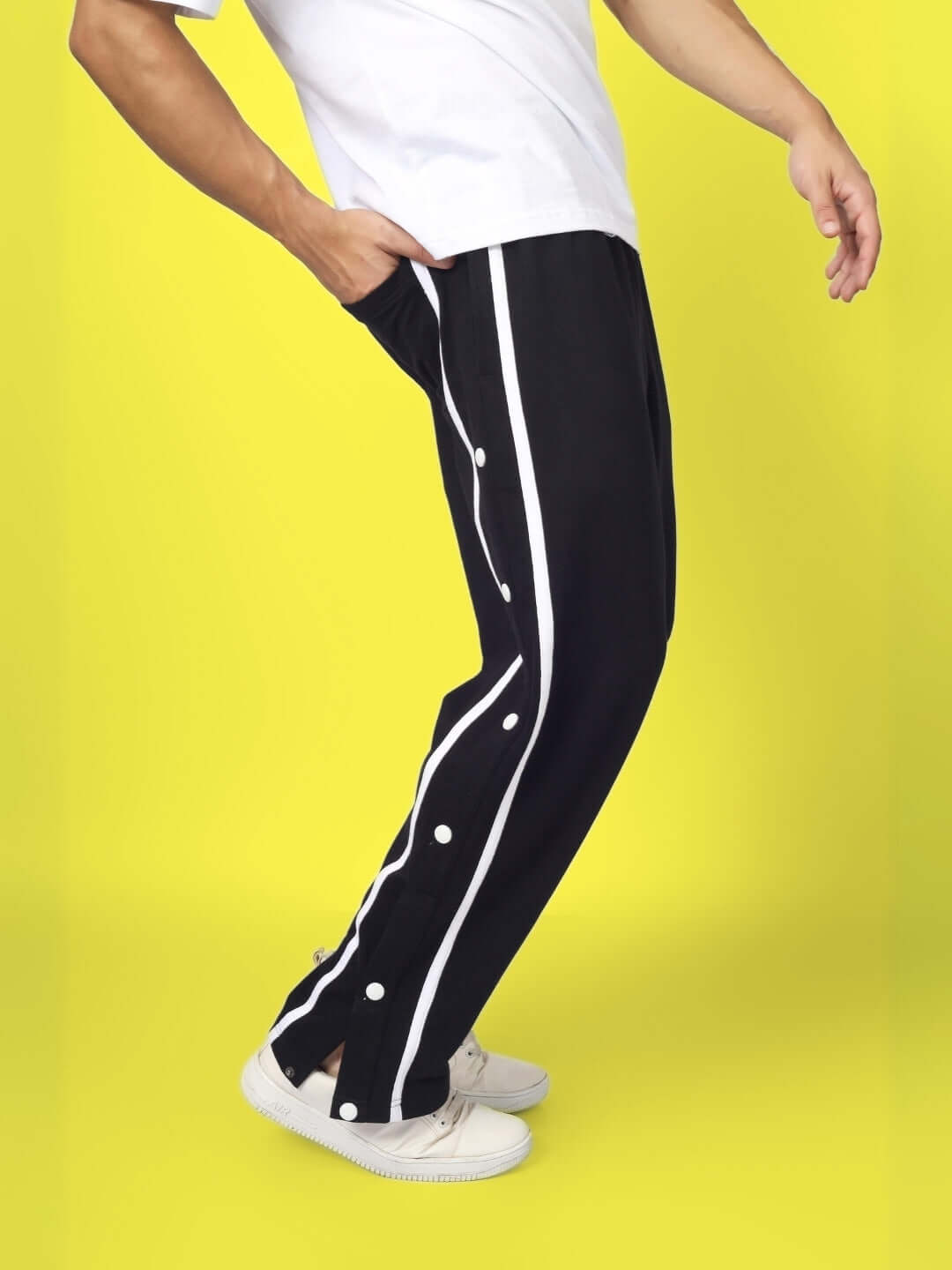 Alt Tag: Model wearing black contrast panel joggers with white stripes, made to order by DUDS, featuring customizable fit, side view.