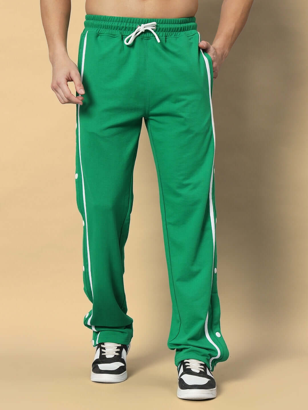 Green contrast panel jogger pants with white stripe detail, designed by DUDS, featuring drawstring waist and customizable fit options.