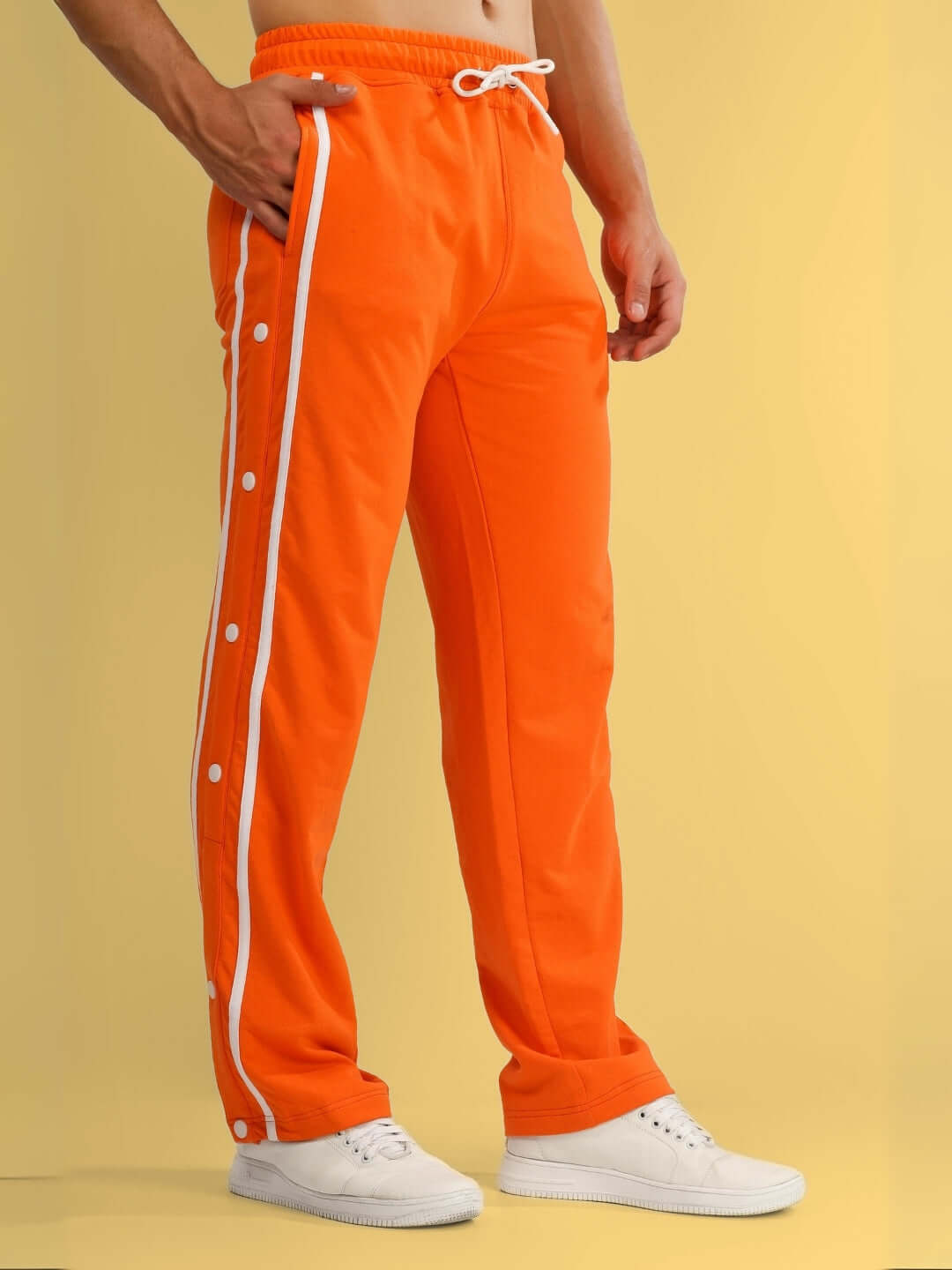 Orange contrast panel jogger pants with white stripe details, showcasing custom tailoring options by DUDS.