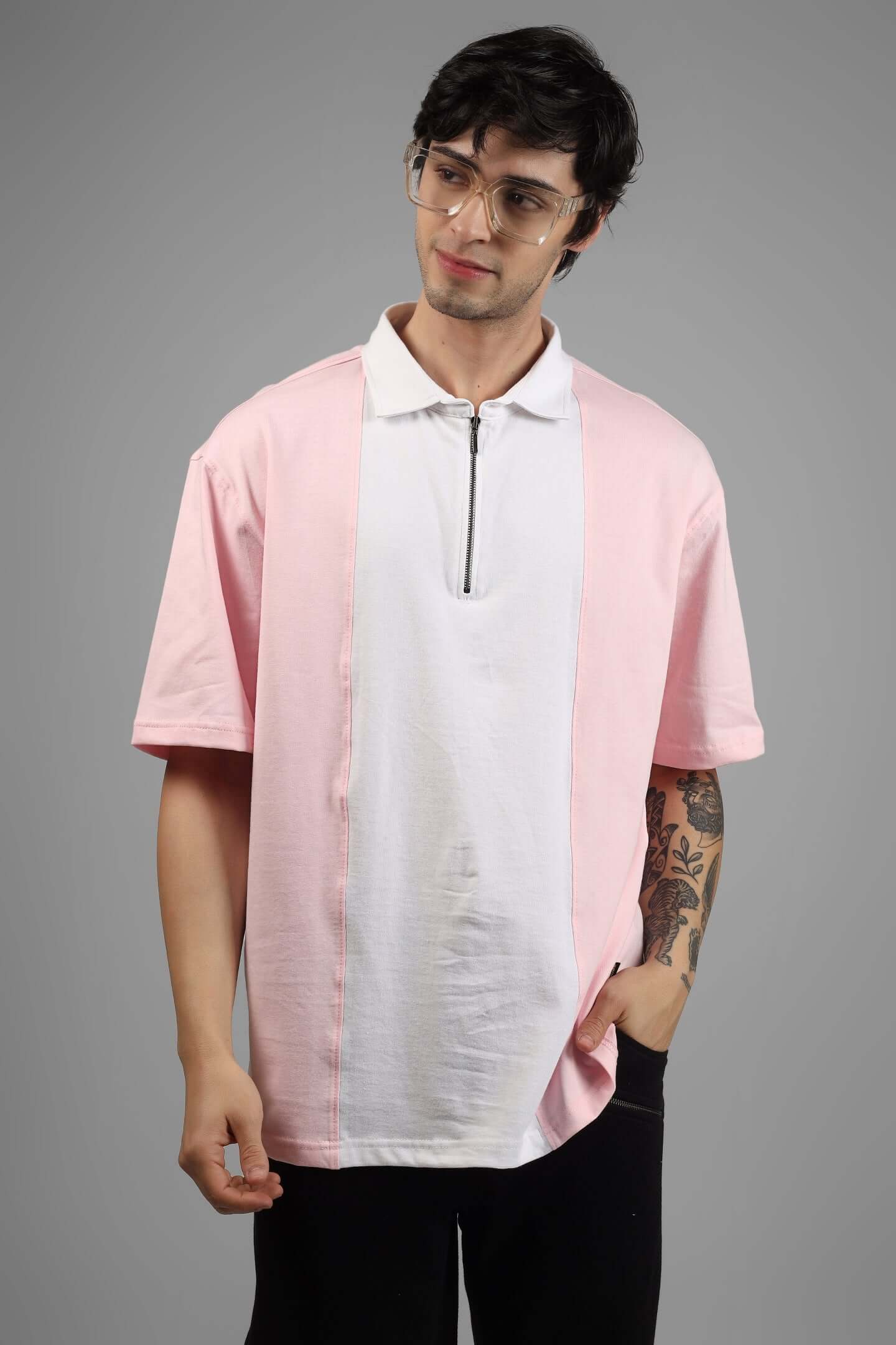 Model wearing an oversized blush pink and white contrast polo t-shirt with half sleeves and metal zipper, made from premium 100% cotton.