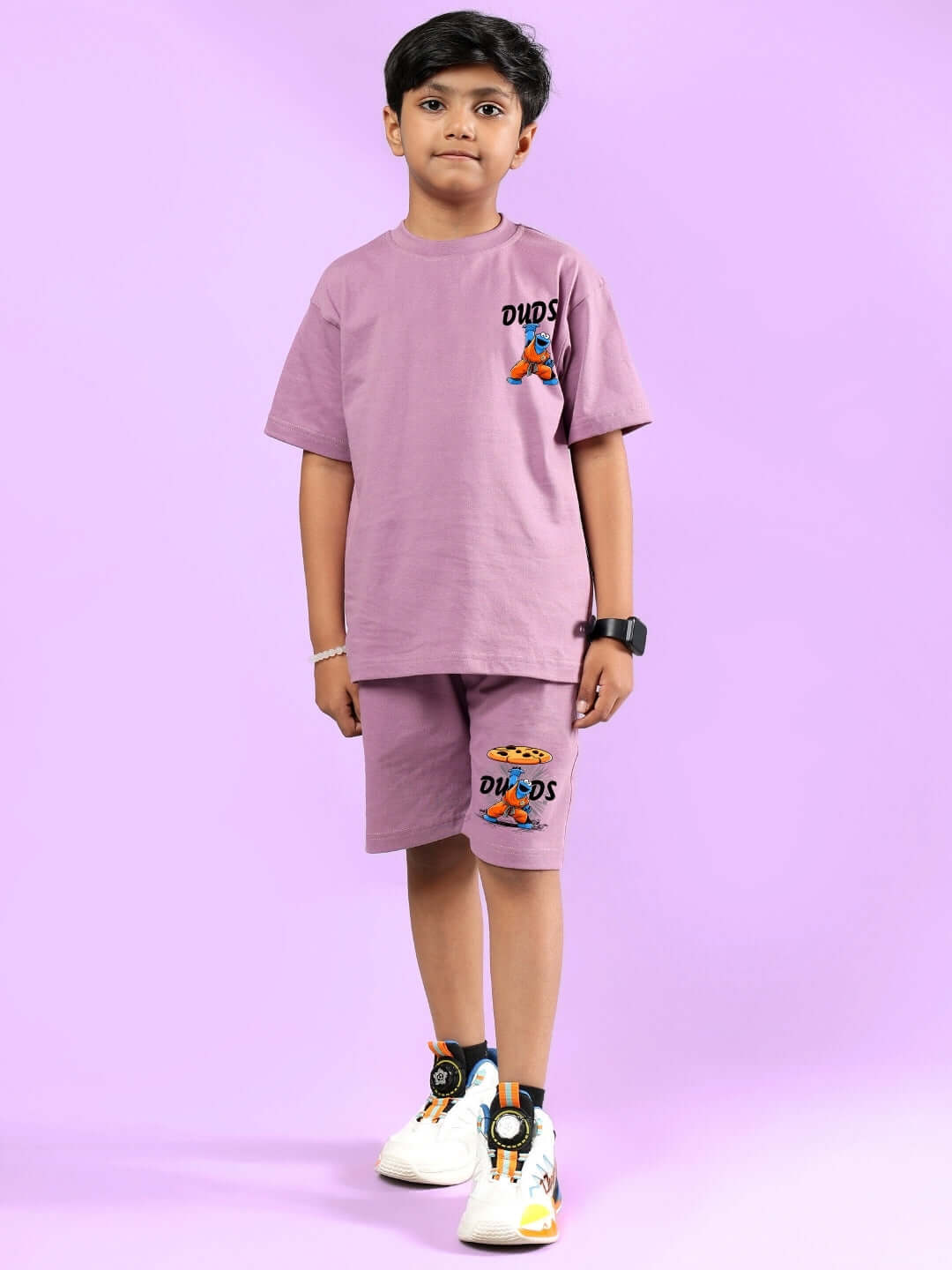 Child wearing Cookie Monster printed co-ord set in plum purple from DUDS, showcasing comfortable and stylish fit for boys and girls.