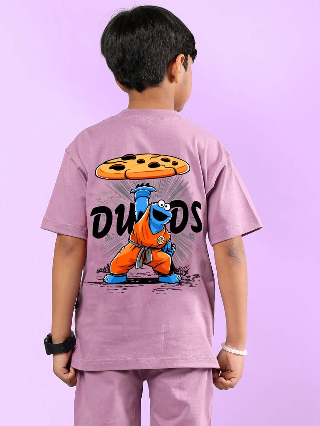 Child wearing COOKIE MONSTER PRINTED T-SHIRT FOR BOYS & GIRLS PLUM PURPLE, featuring a cartoon print on the back.
