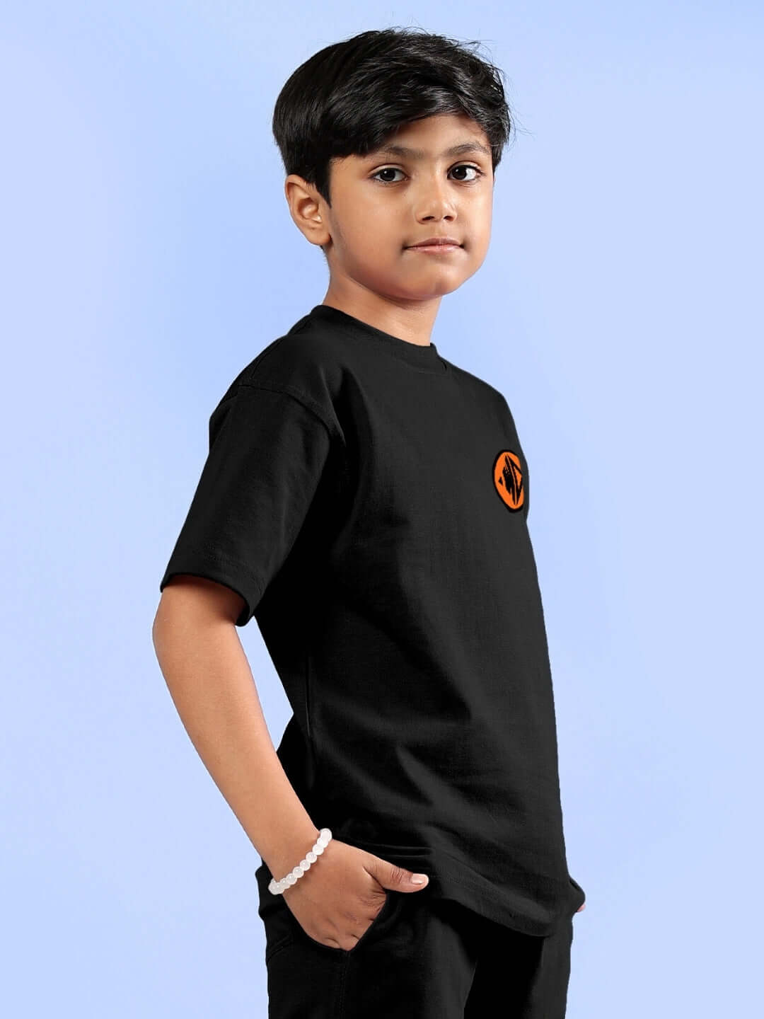 Boy wearing black COOL GOKU printed t-shirt by DUDS, suitable for boys and girls, customizable fit through prepaid orders.