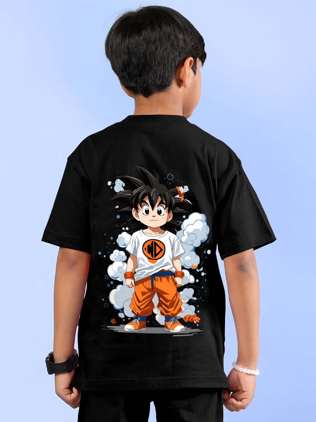 Child wearing a black t-shirt with a colorful Goku print, perfect for boys and girls, showcasing custom fit options.