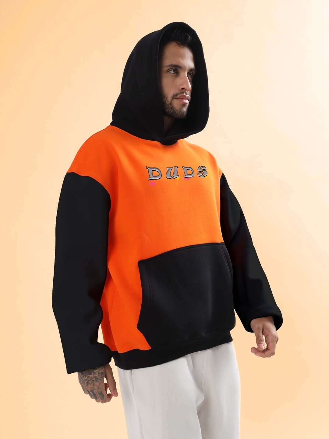 Man wearing COOL TEDDY FLEECE COLORBLOCK OVERSIZE HOODIE ORANGE BLACK with bold colorblock design perfect for street style fashion.