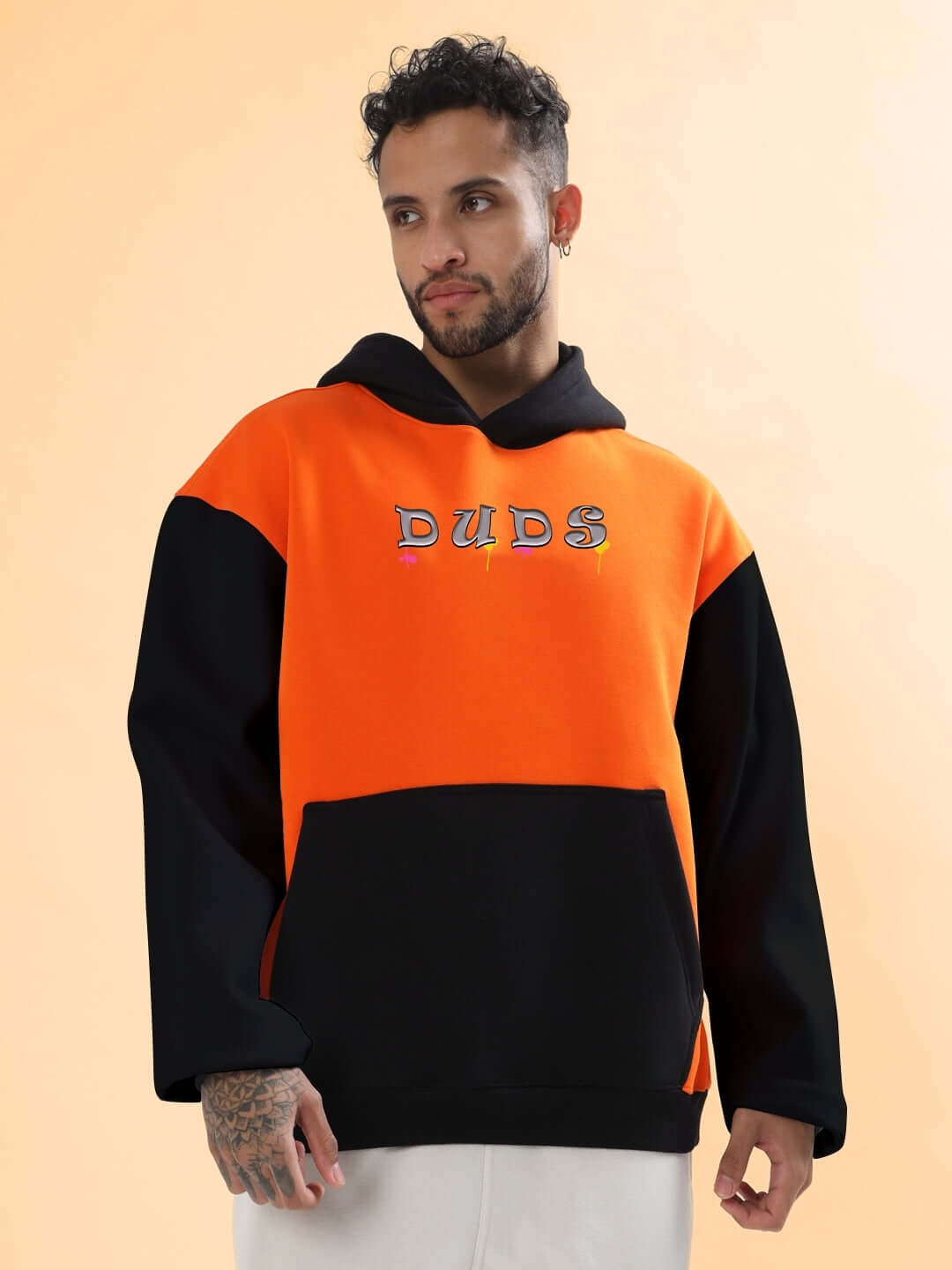 Man wearing COOL TEDDY FLEECE COLORBLOCK OVERSIZE HOODIE ORANGE BLACK with striking orange and black colorblock pattern.