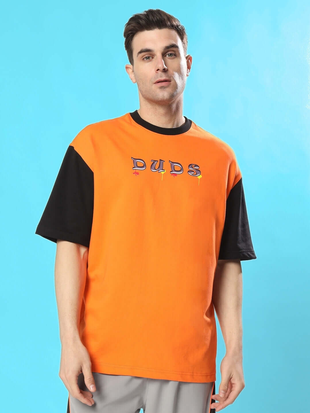 COOL TEDDY oversized orange-black T-shirt made of premium heavy gauge fabric with cotton French terry, featuring the word 'DUDS' on the chest.