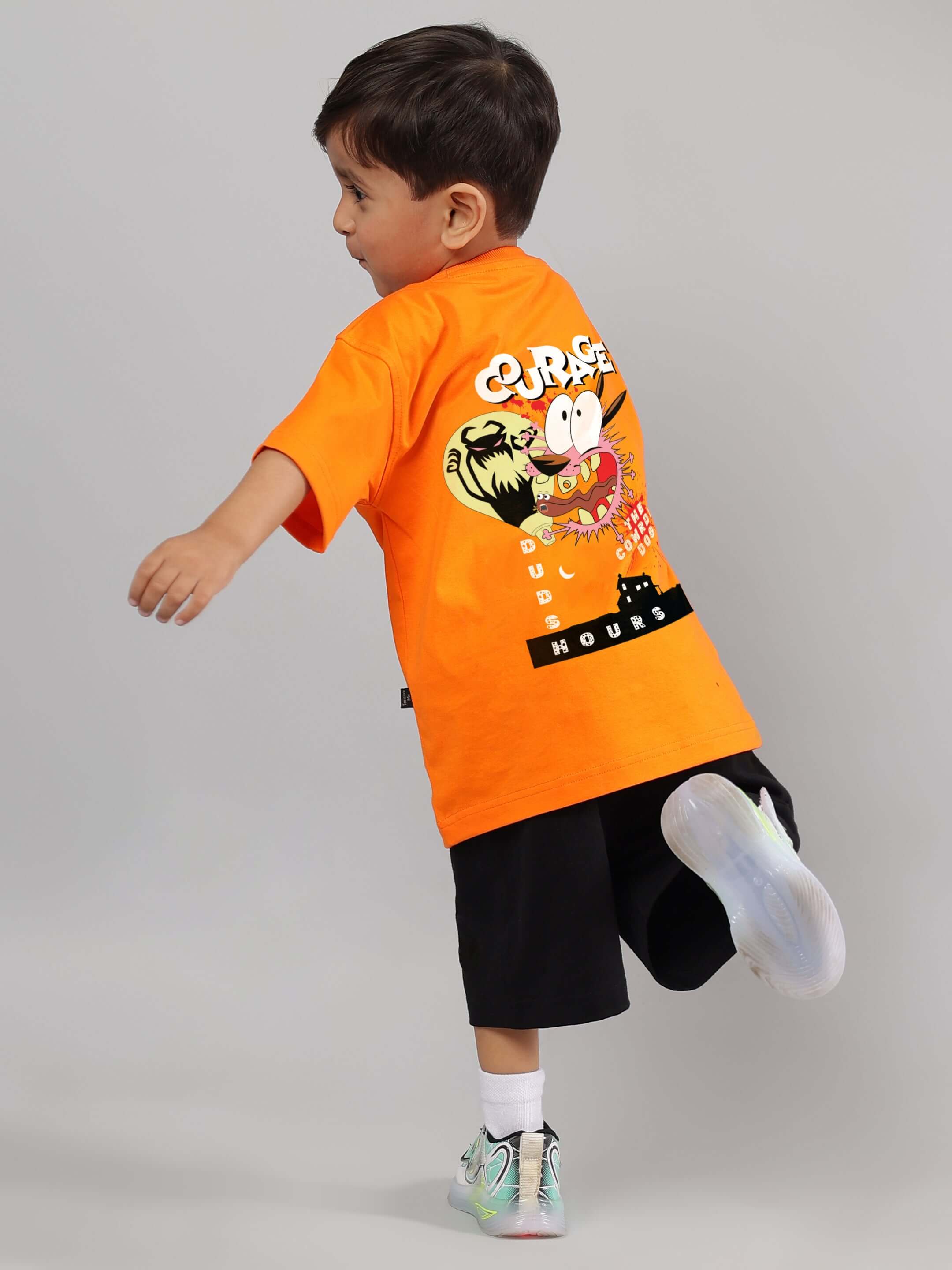 Young child in Courage Toon Co-Ord for Boys Girls Orange-Black, wearing vibrant cotton tee with cartoon print, showcasing playful fashion for kids.
