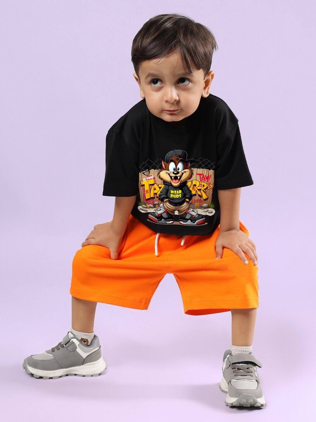 Alt Tag: Young child wearing CRAZY RAPPER CO-ORD FOR BOYS GIRLS AND BLACK-ORANGE, featuring a bold t-shirt design and orange shorts, front view.