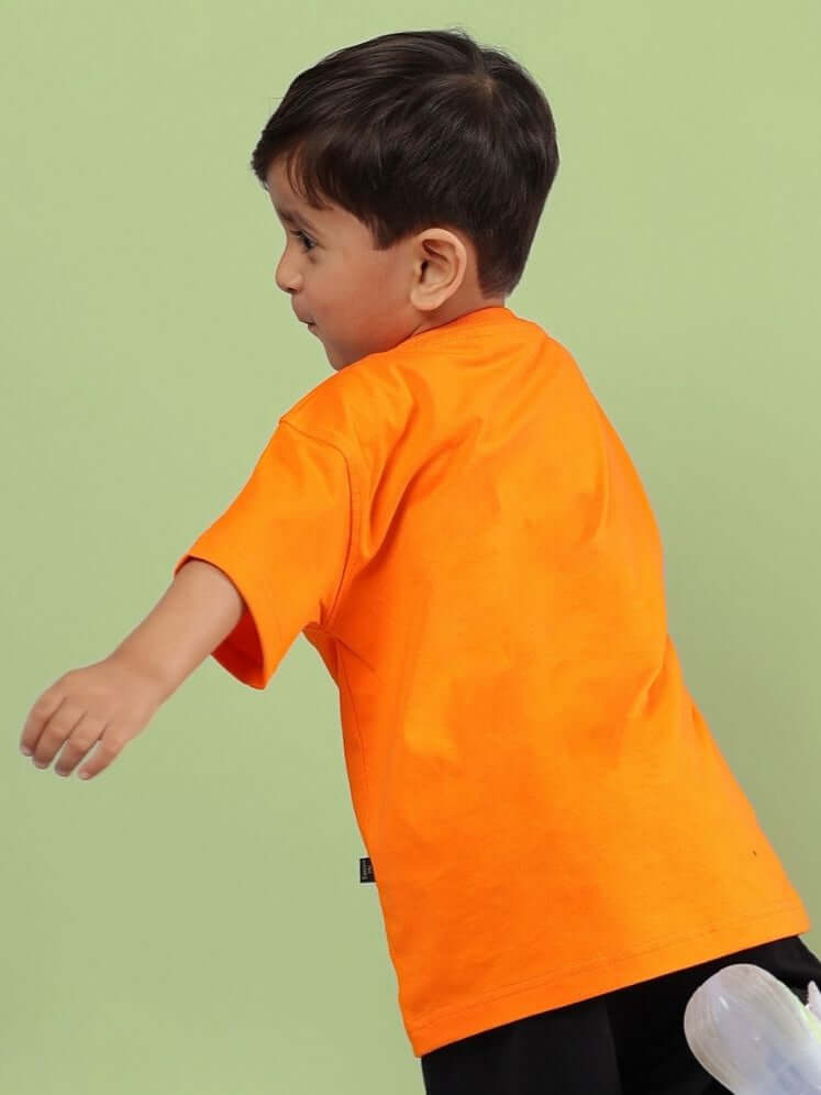 Boy wearing CRAZY RAPPER T-SHIRT FOR BOYS AND GIRLS ORANGE back view.
