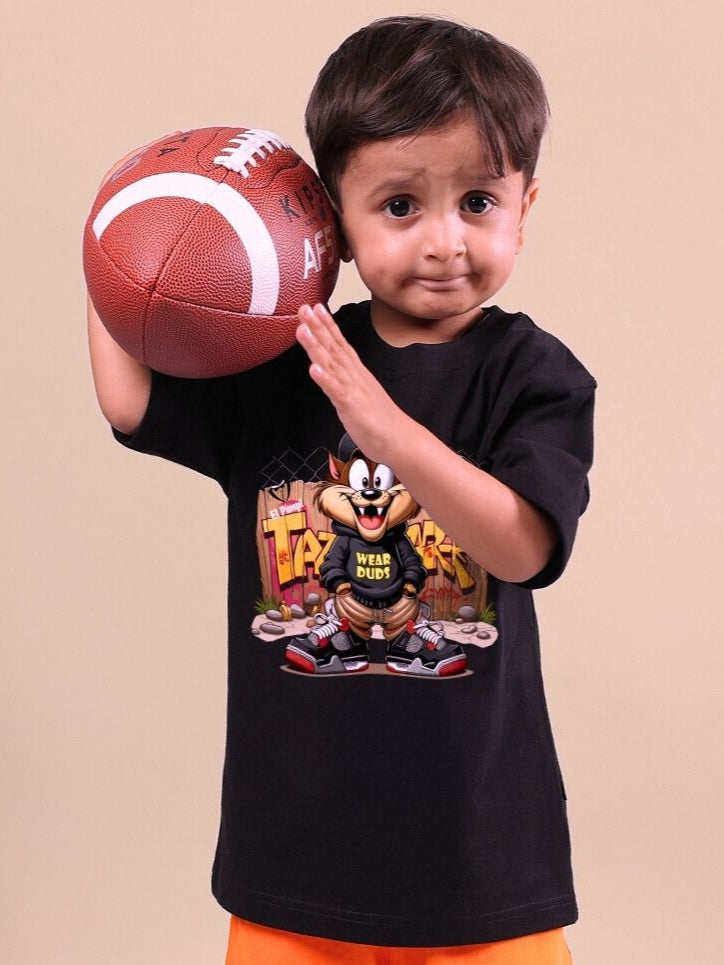 Child wearing a black Crazy Rapper t-shirt holding a basketball, showcasing urban street-style fashion for kids.