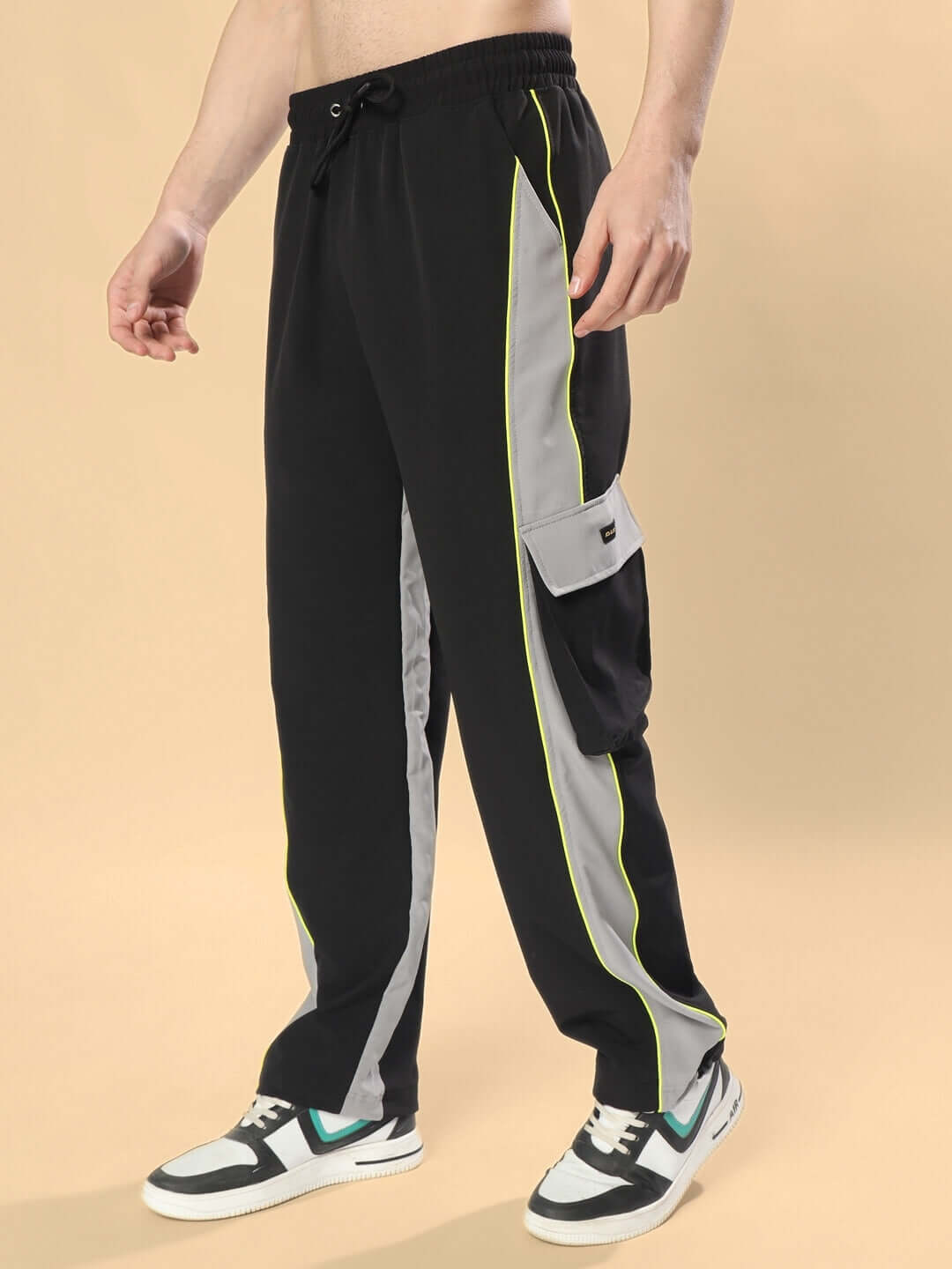 CRAZY RELAXED FIT CARGO PANTS in black-grey with side pocket and neon trim detail, shown on model for customizable fit.