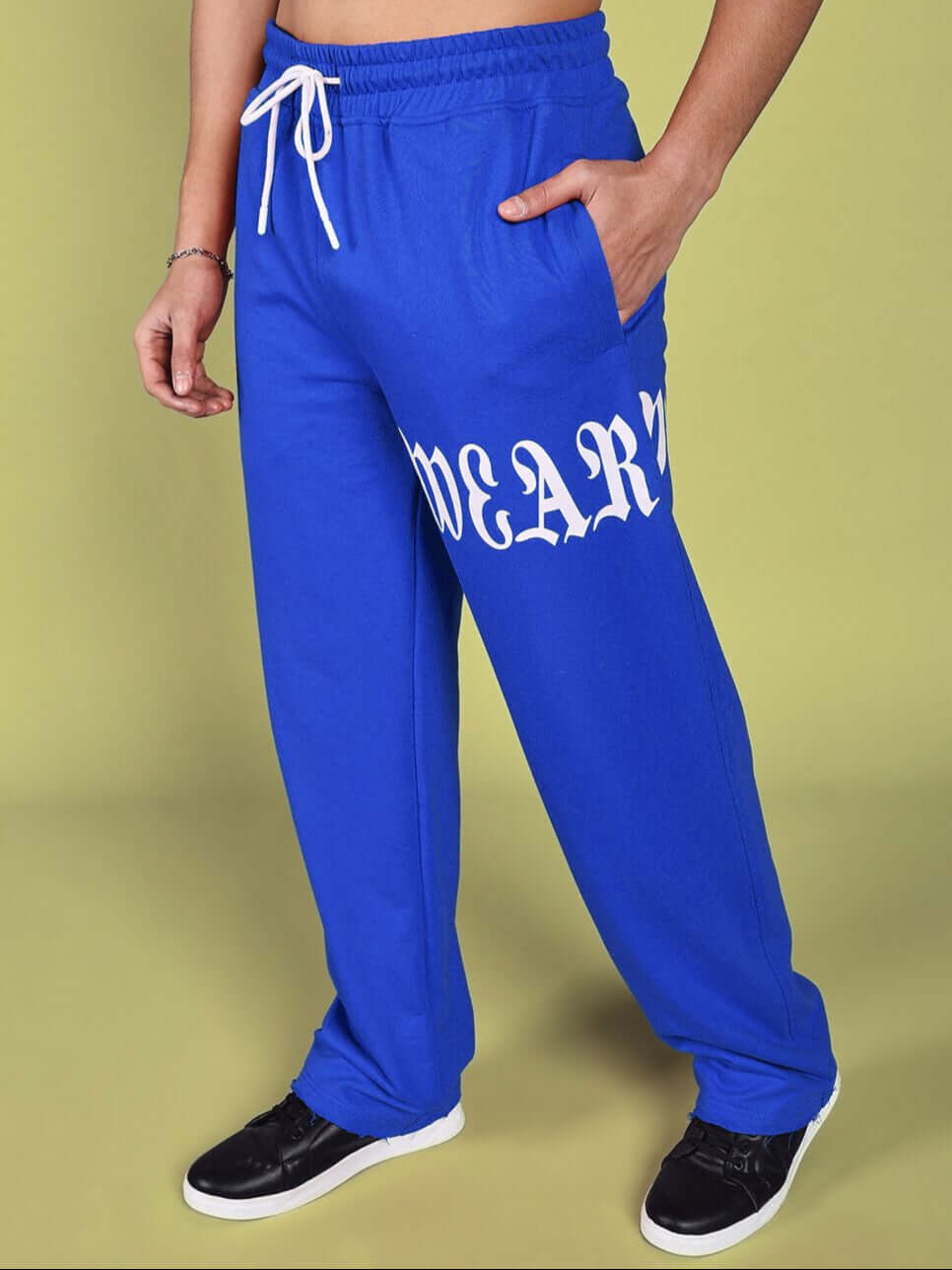 Person wearing blue CRIMSON RELAXED FIT JOGGER by DUDS, featuring white drawstring and print, highlighting the casual style.
