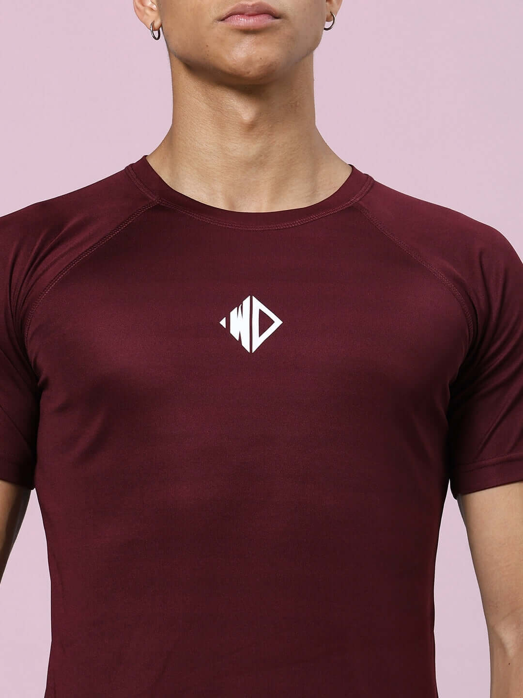 Cristinio maroon regular fit t-shirt in sports polyester, ideal for casual wear, manufactured in India. Model wearing t-shirt.