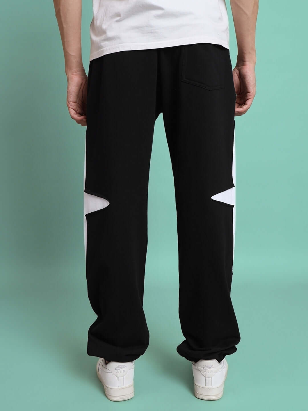 Back view of black Crossed Star Jogger pants with unique white star design. Custom fit option available for prepaid orders.