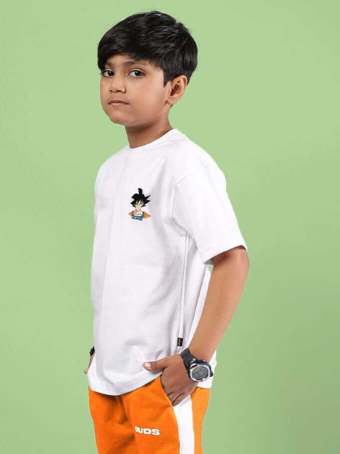 Child wearing a white crossover t-shirt with a small cartoon character design, paired with orange DUDS pants. Ideal for boys and girls.