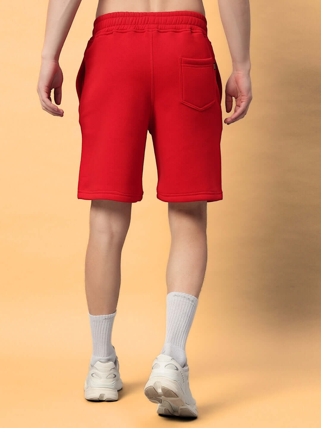 Back view of person wearing CUPCAKE COTTON FLEECE SHORTS RED, showcasing vibrant color and comfortable fit.