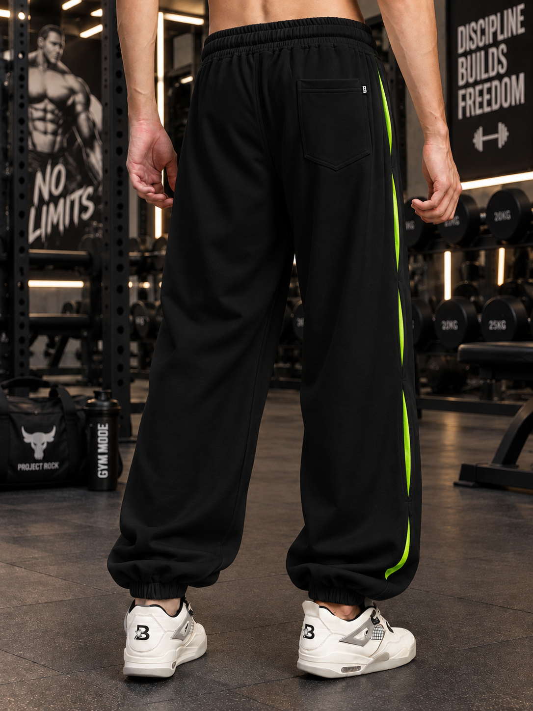 CURIOUS GRAPHIC COTTON TERRY JOGGERS BLACK with neon stripe detail, worn in gym setting for workout style