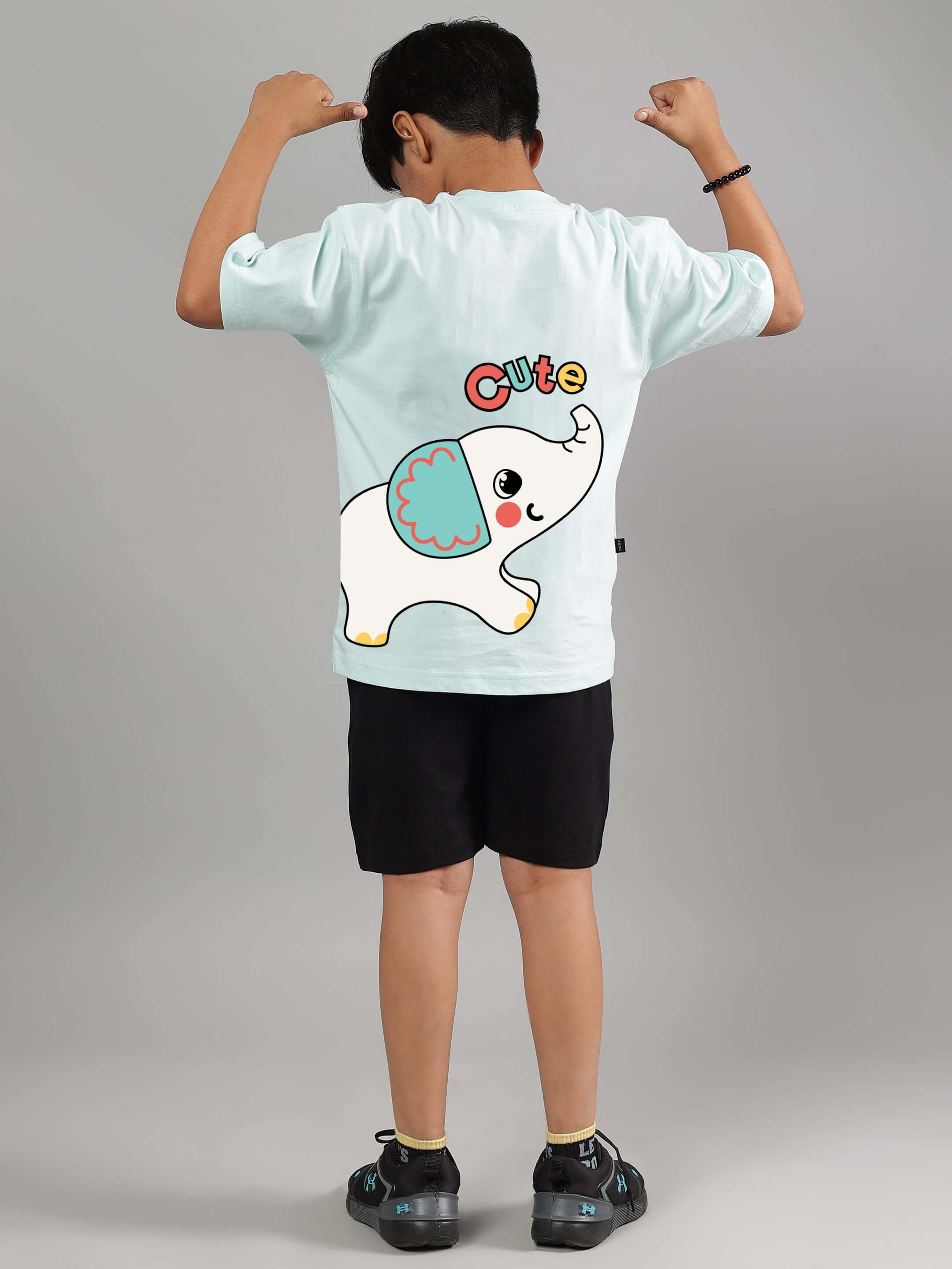 Boy wearing a cute elephant co-ord set in light blue and black, featuring a playful elephant print on the back of the shirt.