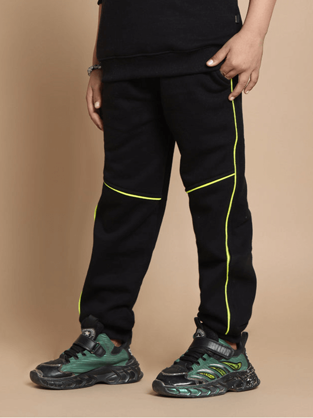 Child wearing black Angry Bird fleece co-ord, highlighted with neon details, matching pants and shoes for boys and girls.