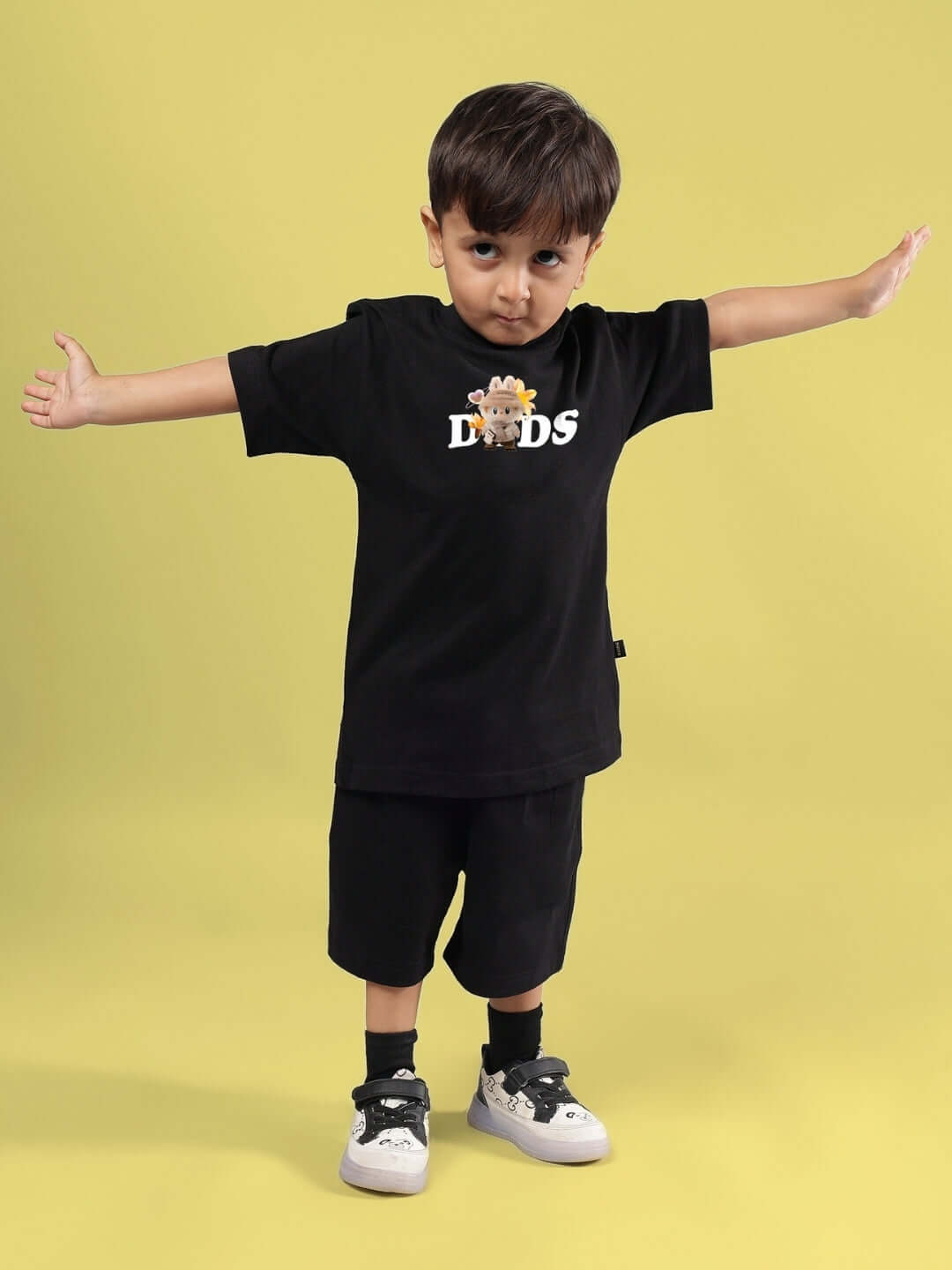 Child wearing black Cute Monsters co-ord set with a playful monster graphic, perfect for boys and girls. Made to order by DUDS.