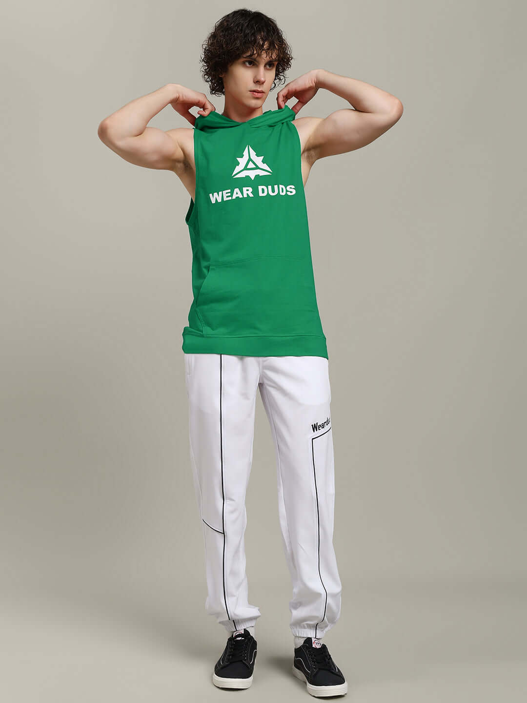 Person wearing CYBRAN GYM HOODED T-SHIRT GREEN for athleisure style and gym workouts standing confidently in studio