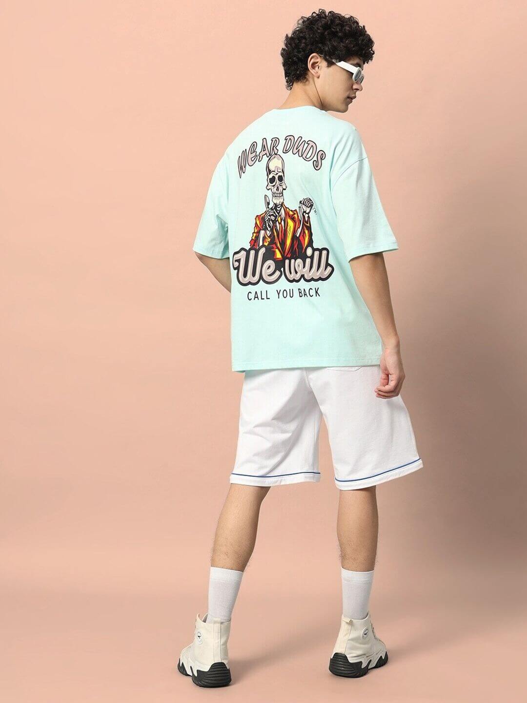 Model wearing CALL YOU BACK OVER-SIZED T-SHIRT ICE BLUE with graphic print, perfect for casual style, showcasing a trendy look.