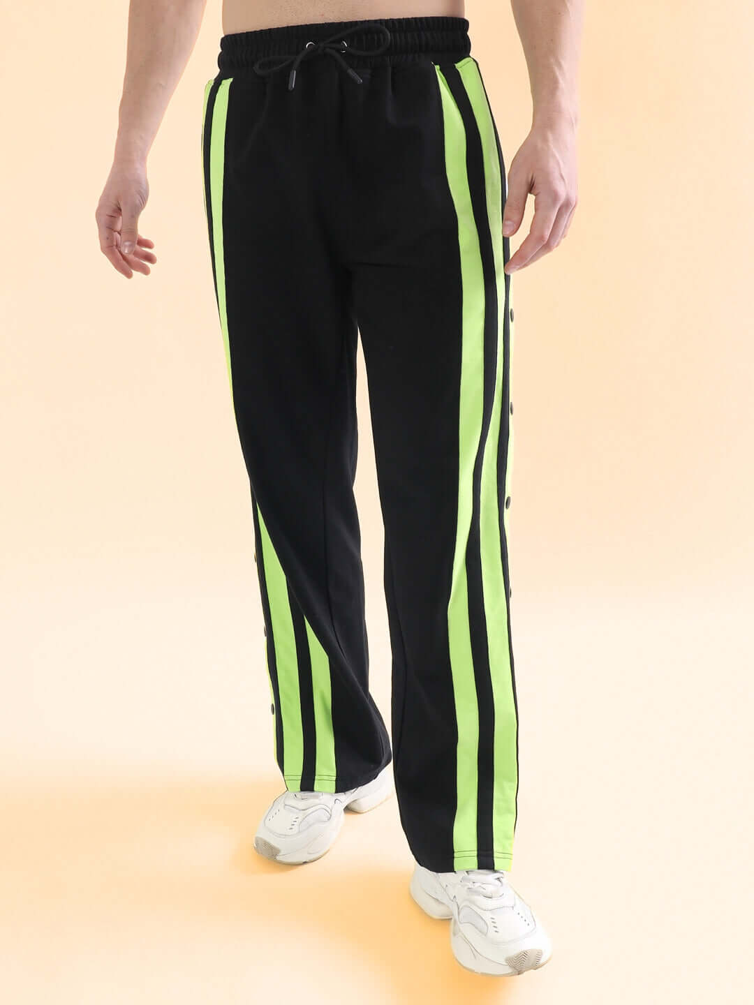 Black joggers with neon green stripes, custom fit available, made by DUDS tailors. Shipping takes 7-10 days as a made-to-order product.