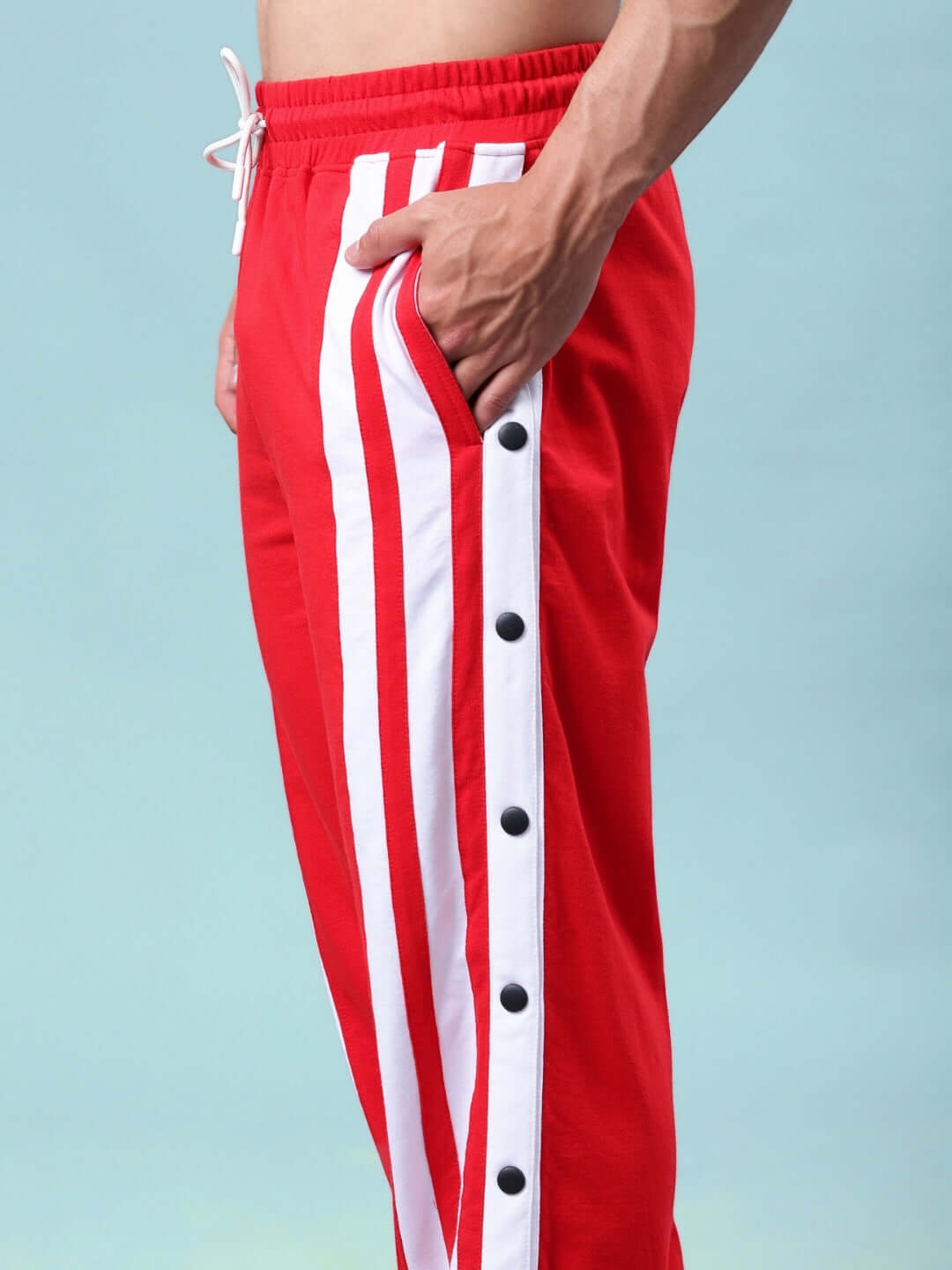 Side view of Dancer Joggers in red and white with stripe details from DUDS, tailored for custom fit and comfortable wear.