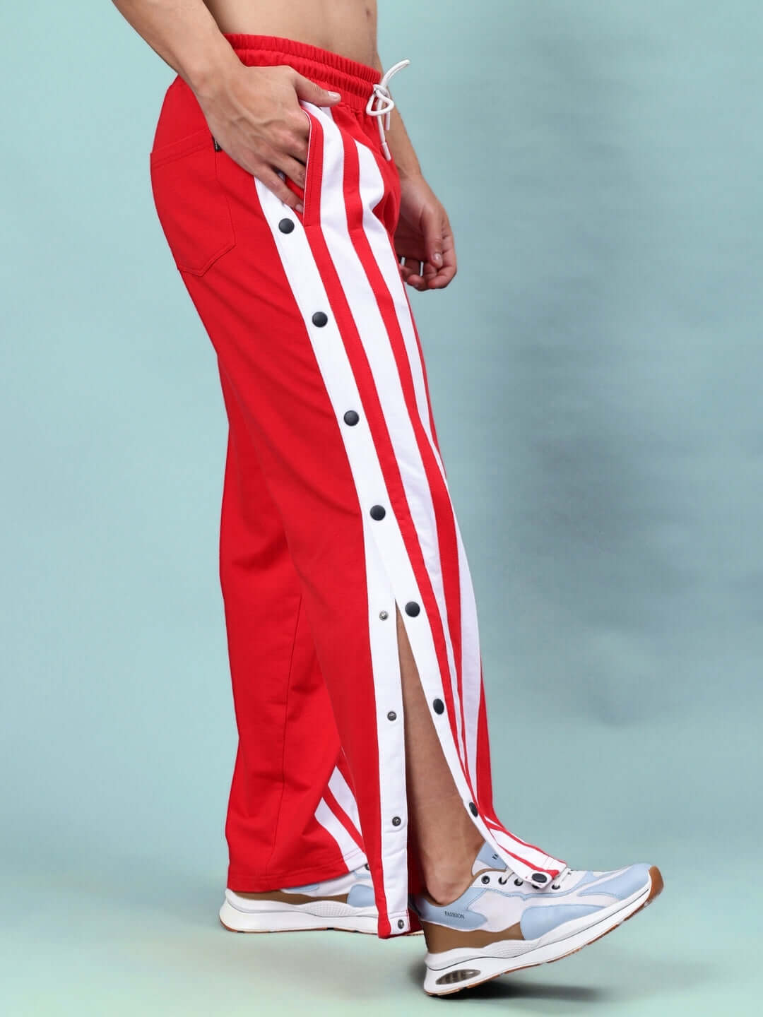 Side view of red-white Dancer Joggers with button-up side panels, showcasing the sporty, customized fit design by DUDS.