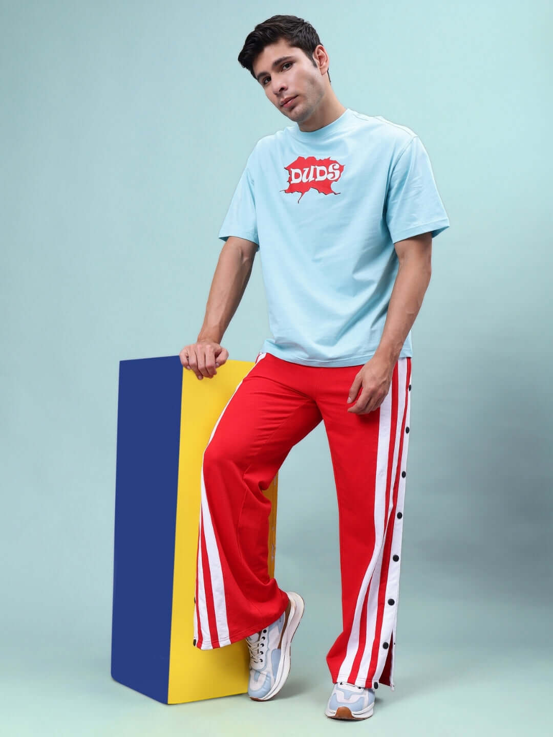 Model wearing Dancer Joggers in Red-White by DUDS, showcasing sporty style with customizable fit. Made to order for ultimate comfort.