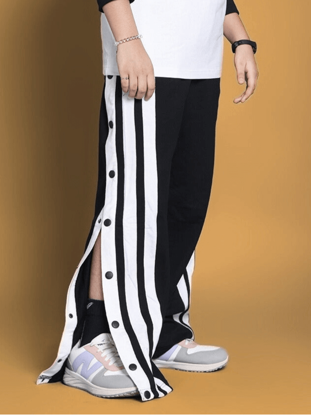 Child wearing black and white striped Dancer Jogger with side buttons, custom fit option available at DUDS.