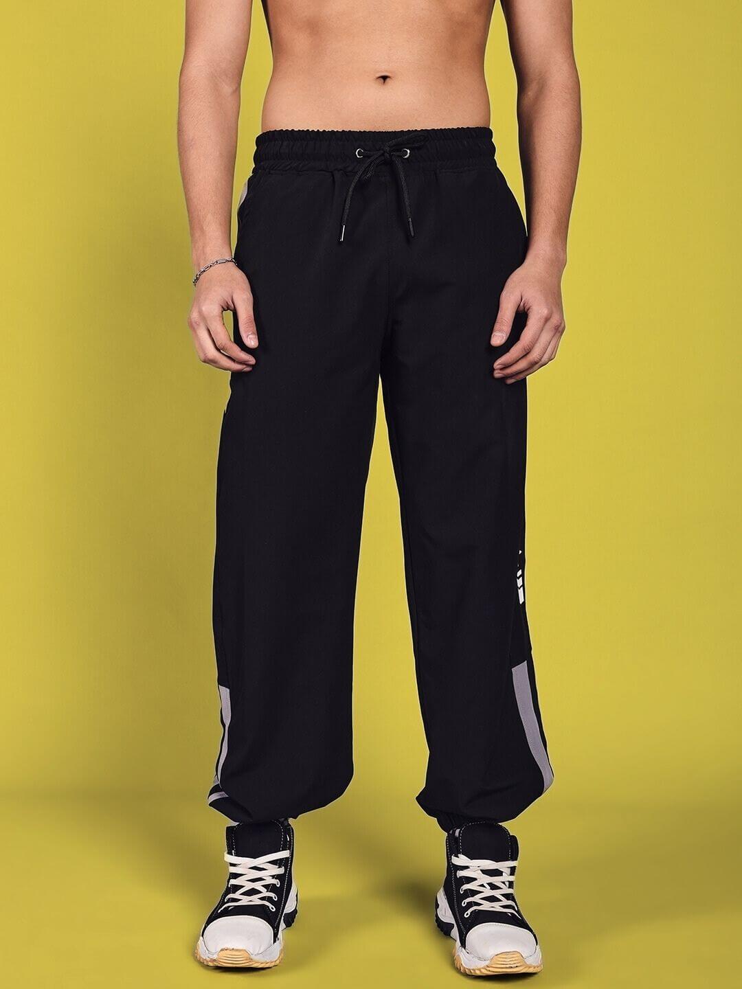 Model wearing Danny Relaxed Fit Black Cargo Pants with drawstring waist, showcasing customizable fit options for tailored comfort.