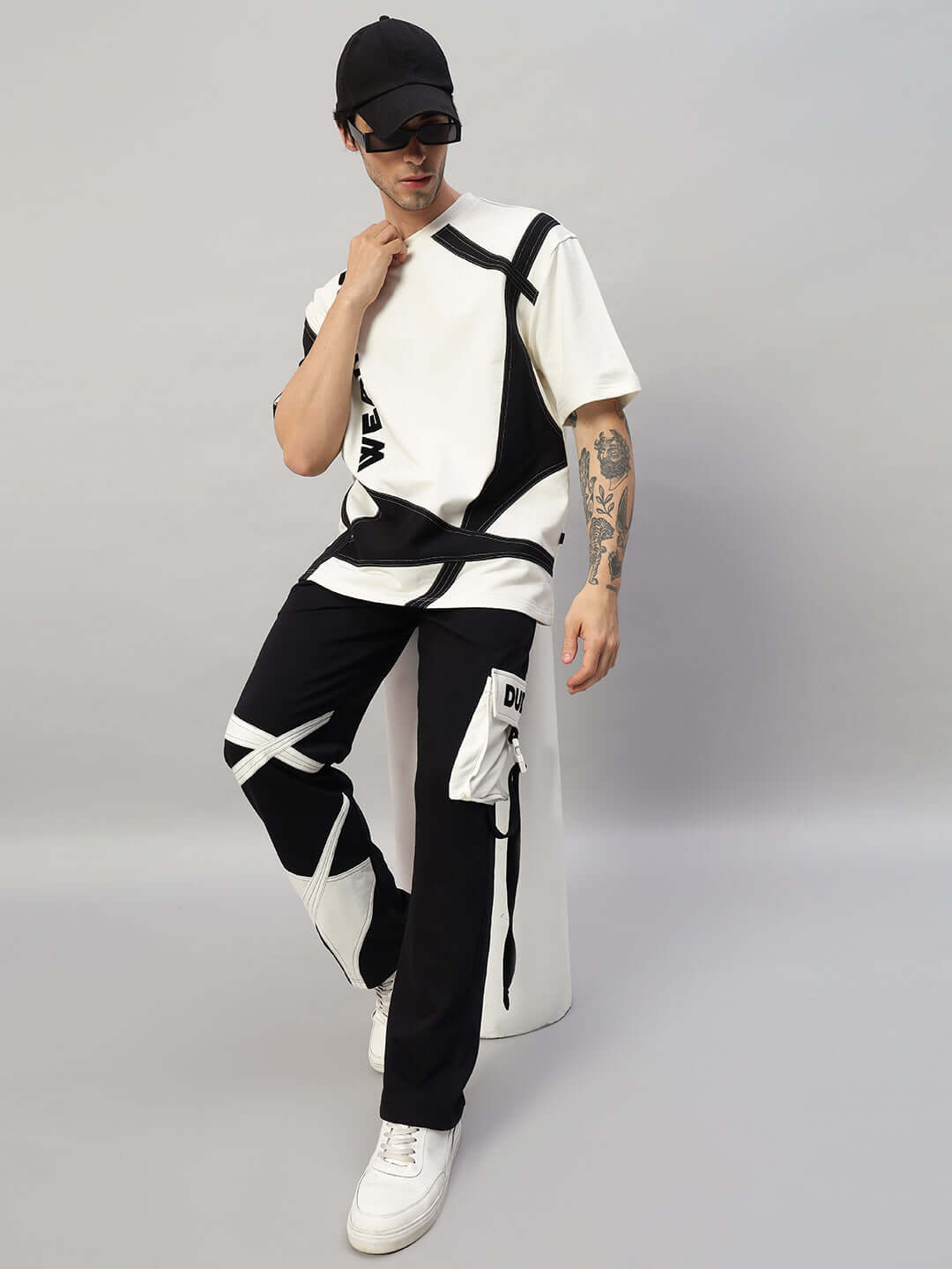 Model wearing David oversized co-ord set in off white and black with relaxed fit joggers and elastic waistband, unisex design.