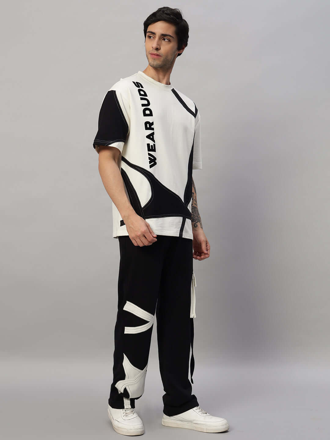 Person wearing DAVID oversized co-ord set in off white-black with relaxed fit joggers, showcasing comfortable and stylish casual wear.