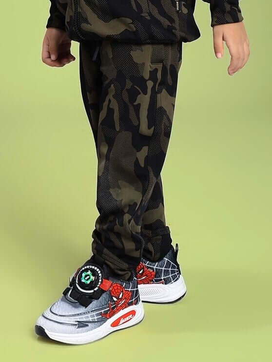 Child wearing DEFENCE JOGGER FOR BOYS AND GIRLS CAMO GREEN with camo pattern, showcasing style and comfort in kids' fashion.