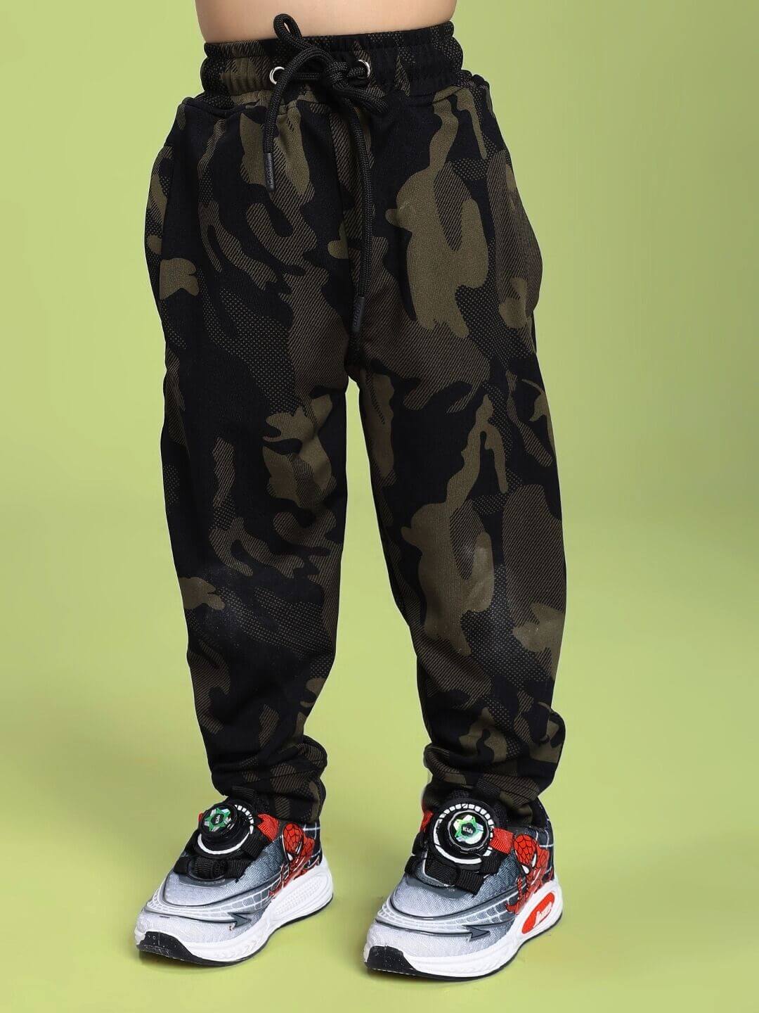 DEFENCE JOGGER FOR BOYS AND GIRLS CAMO GREEN displayed on a child