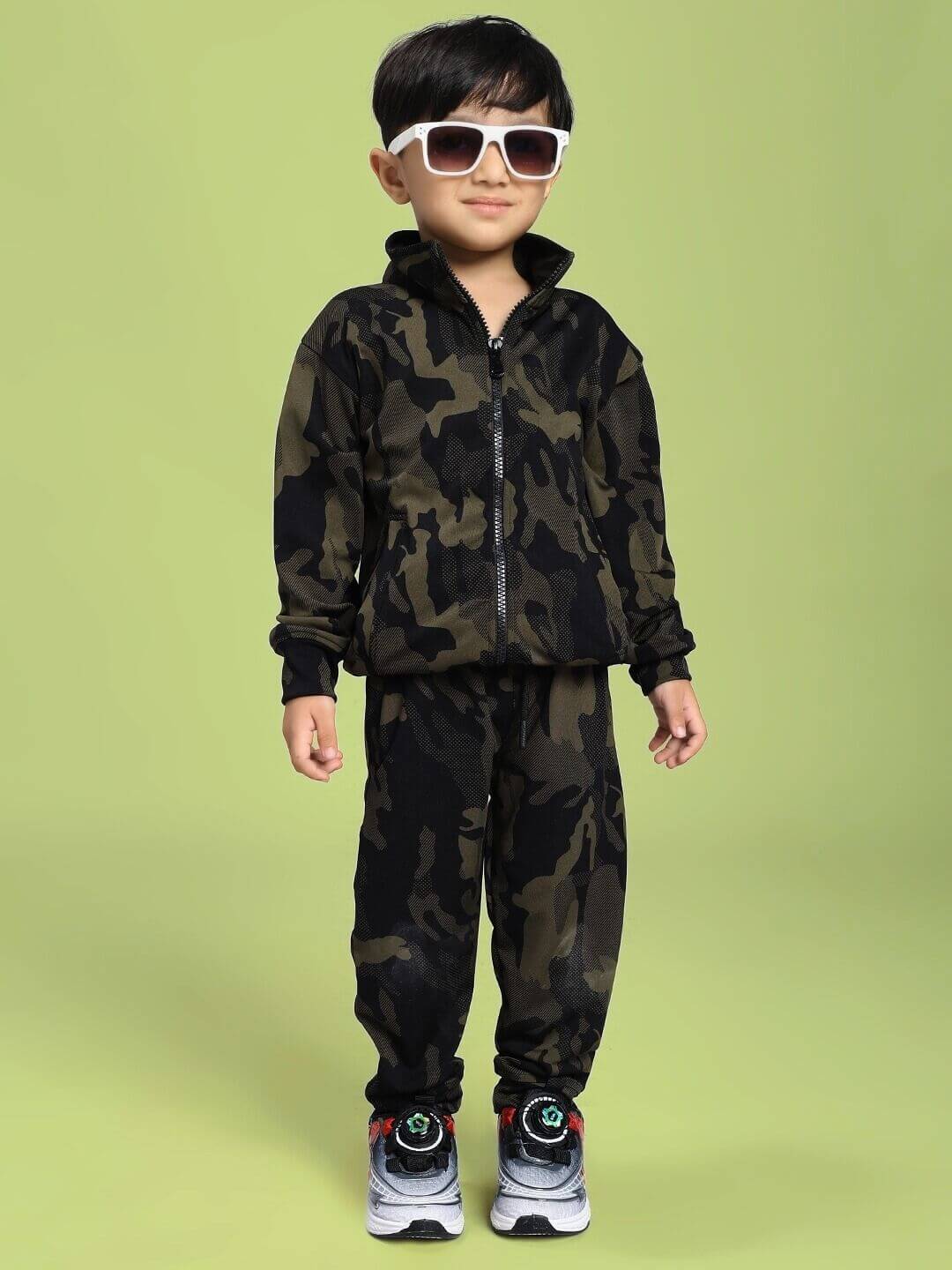 Young child wearing DEFENCE CO-ORD SET FOR BOYS AND GIRLS CAMO GREEN, stylish camouflage outfit ideal for active kids.