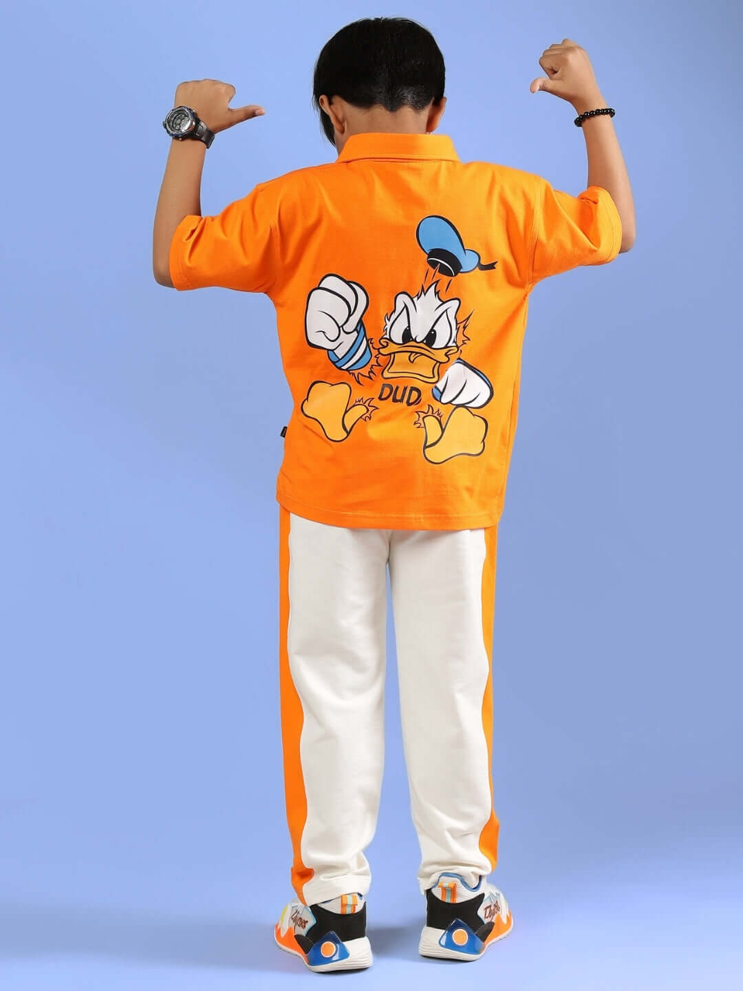 DELIA CO-ORD in orange for boys and girls, featuring a playful design on the back, made by DUDS. Offers custom fit option.