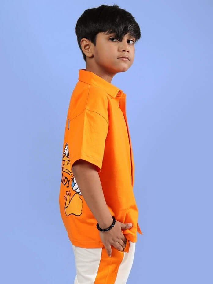Child wearing the DELLA SHIRT FOR BOYS & GIRLS ORANGE, showcasing the vibrant color and playful design for stylish kids.