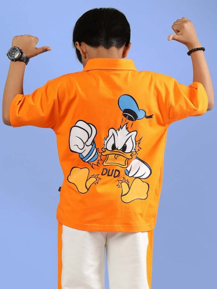 Orange DELLA shirt for kids featuring a cartoon character on the back, designed by DUDS, shown on a child flexing arms.