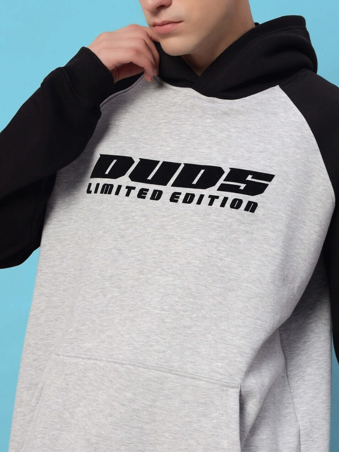 DELUXE FLEECE COLORBLOCK OVERSIZE HOODIE BLACK MELANGE GREY with logo detail on chest.