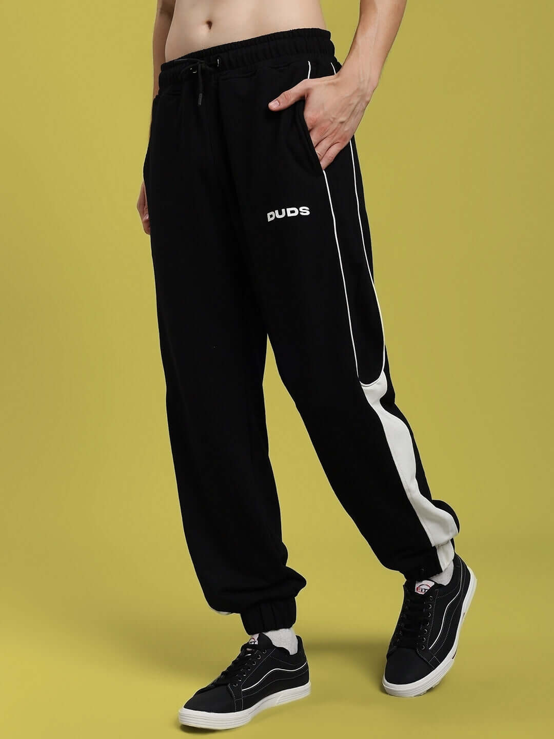 Black relaxed fit joggers by DUDS, featuring a sporty design with white side stripes. Ideal for comfort and style. Custom fit available.