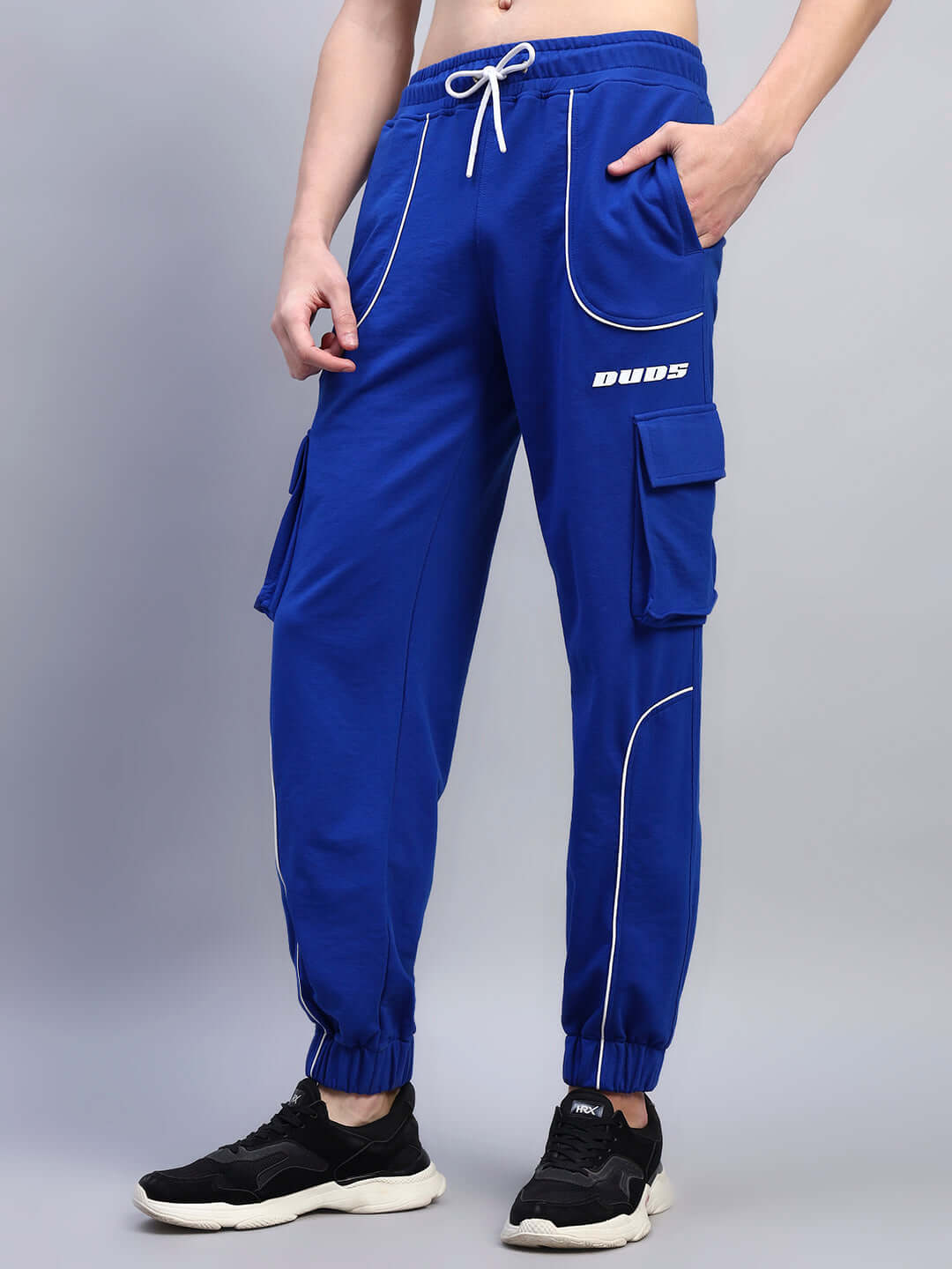 Person wearing blue DEVENO relaxed-fit joggers with pocket details and drawstring.