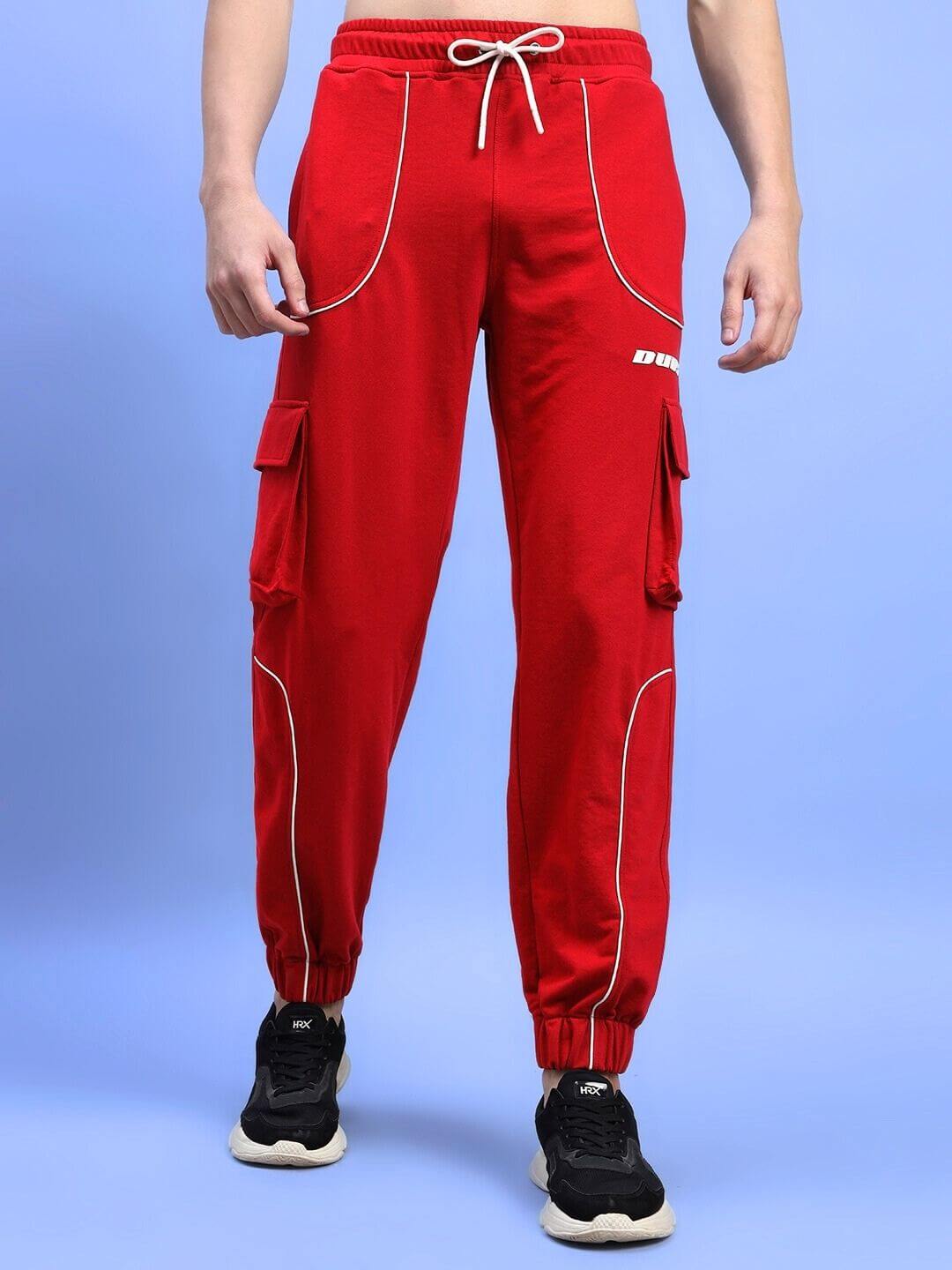 Man wearing red DEVENO relaxed-fit joggers with cargo pockets and drawstring waist for a comfortable, custom fit style.