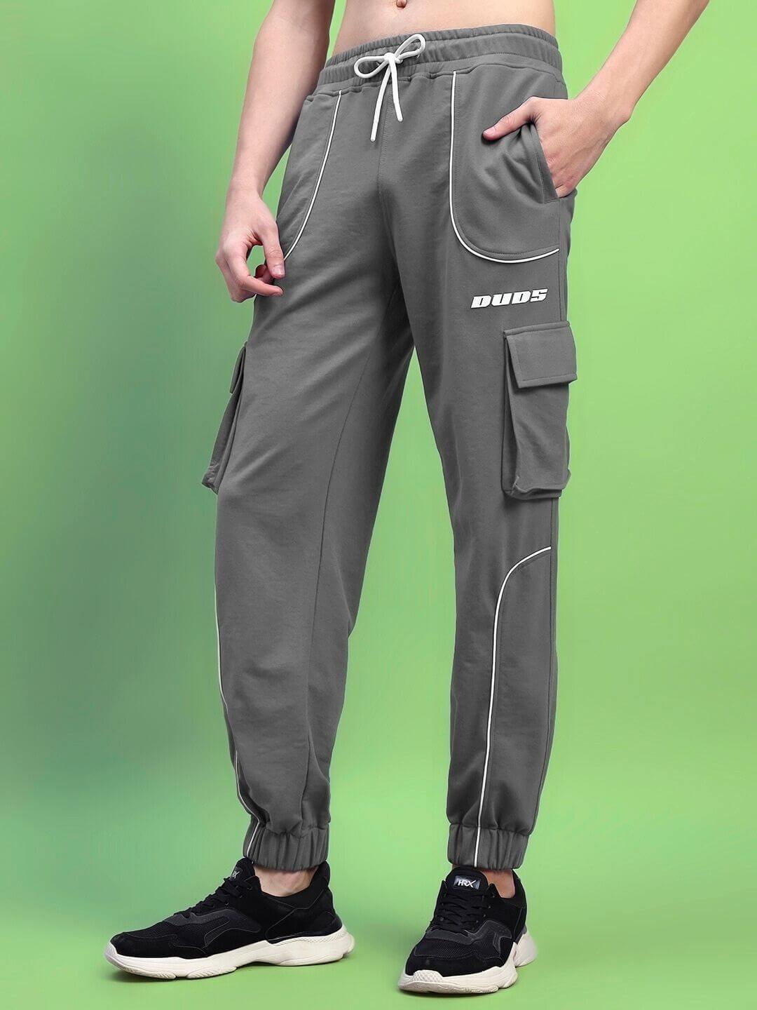 Men's Deveno relaxed-fit grey joggers with pockets, by DUDS, displayed on a model against a green background.