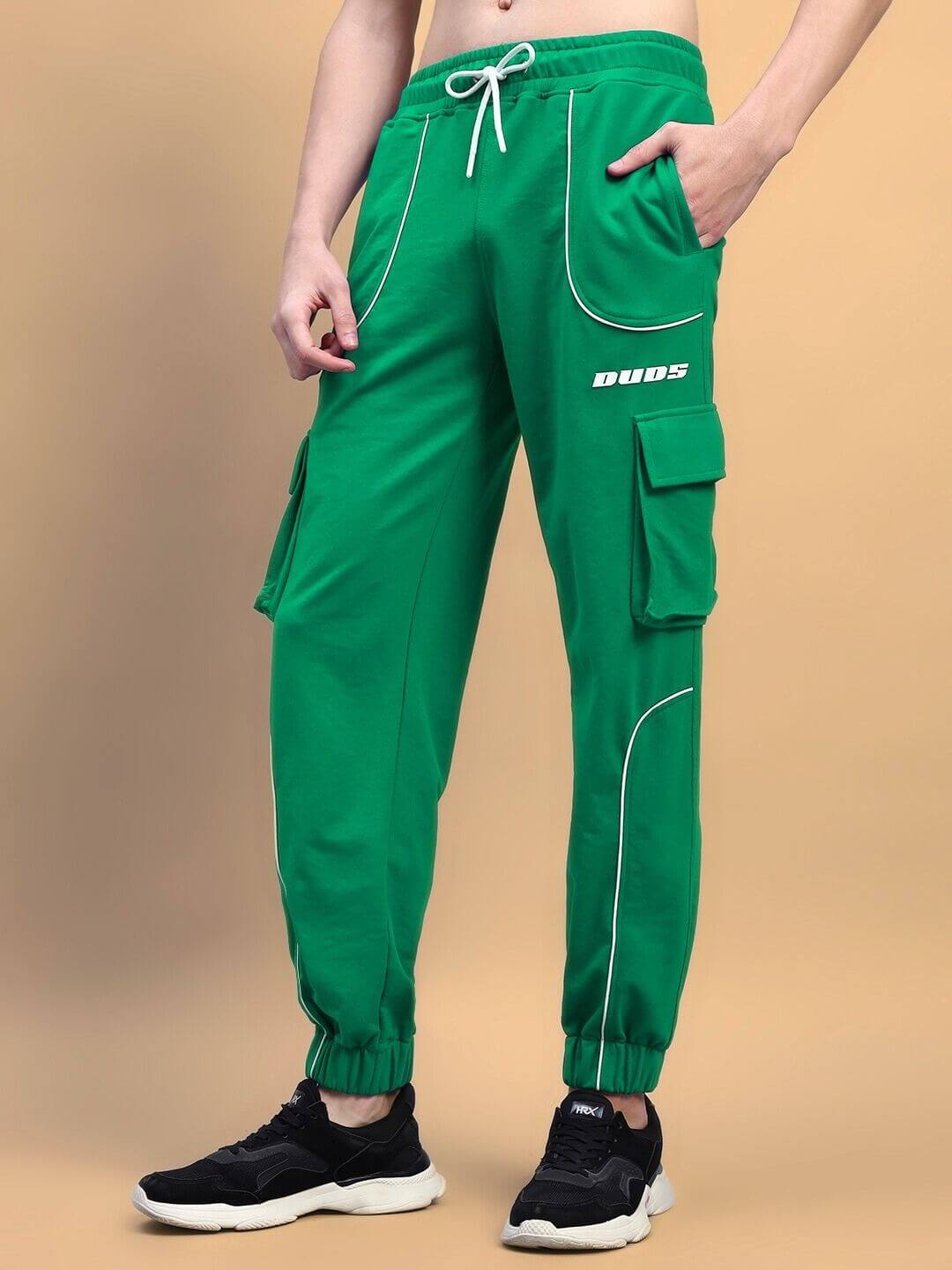 Model wearing Deveno Relaxed-Fit Joggers in Green with cargo pockets and drawstring waist, made by DUDS with custom fit option available.